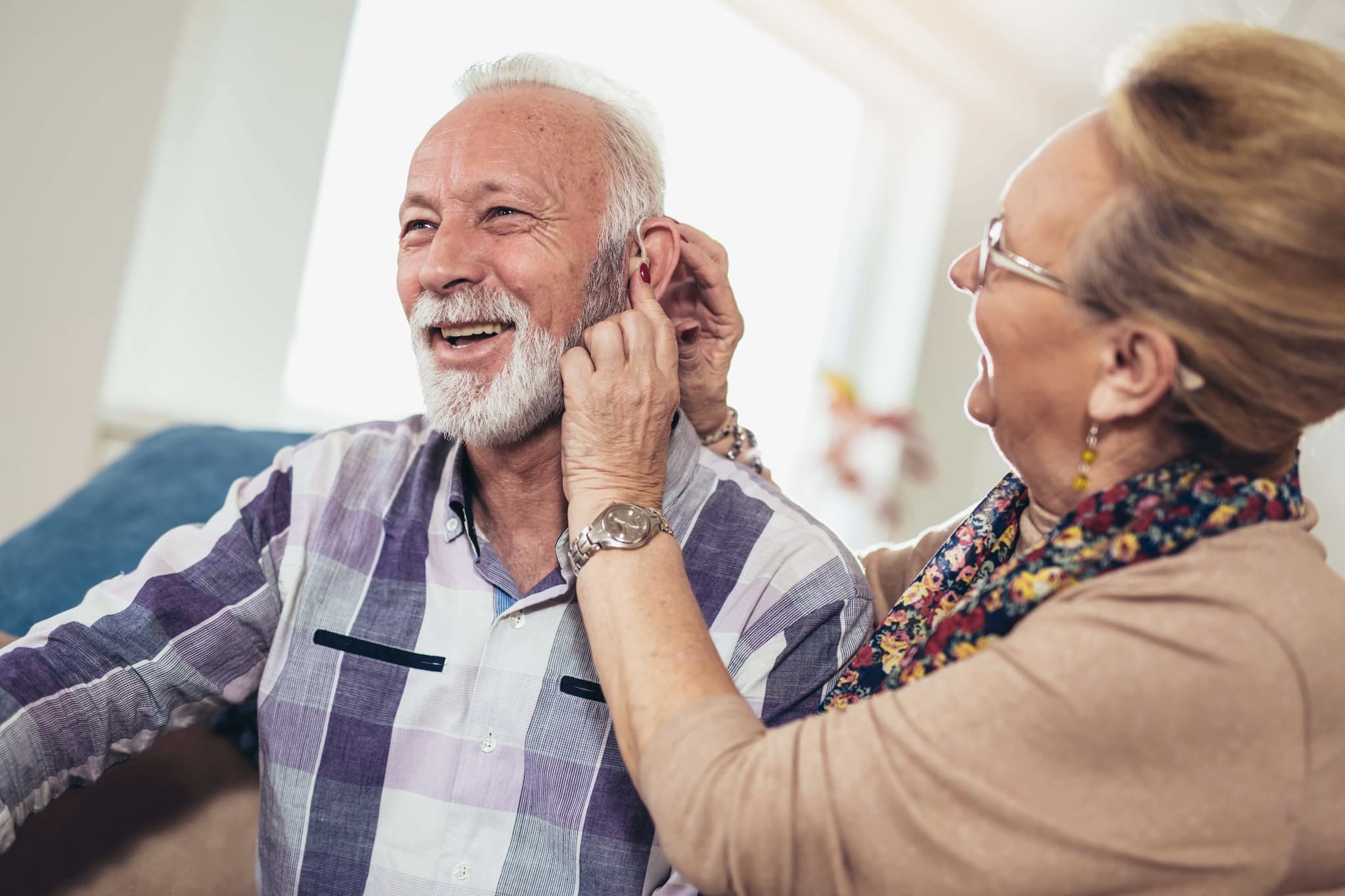 Senior citizen with hearing aid - representing audiology services